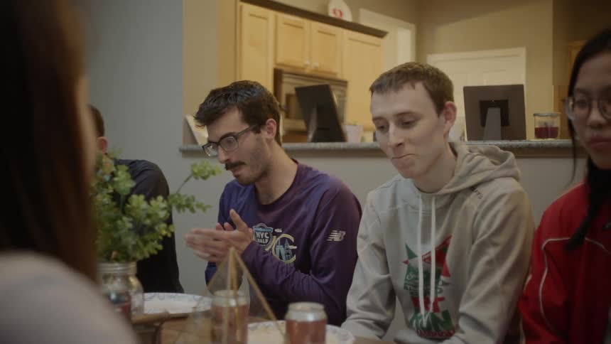 People sit around the table talking and eating