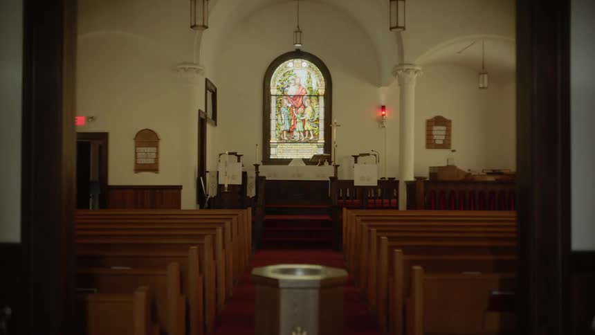 A church with pews and a stained glass window