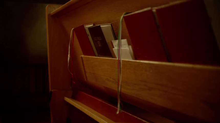 The church seat has bibles in the back