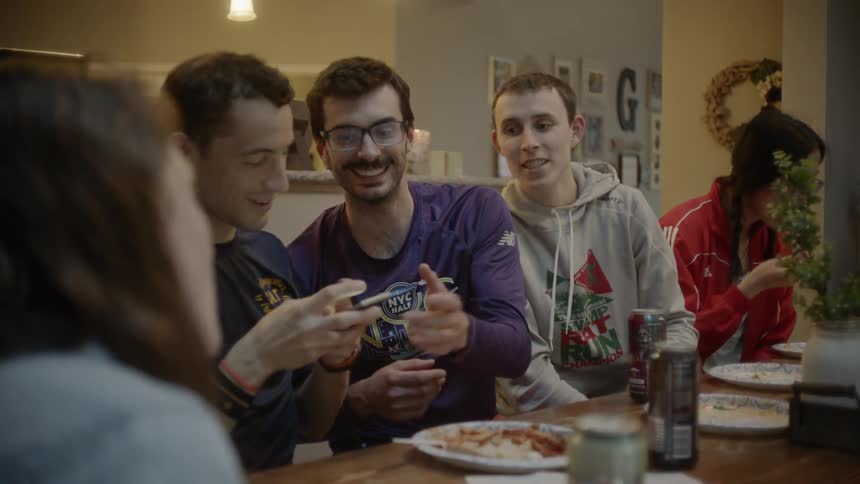 People talk around the table while eating