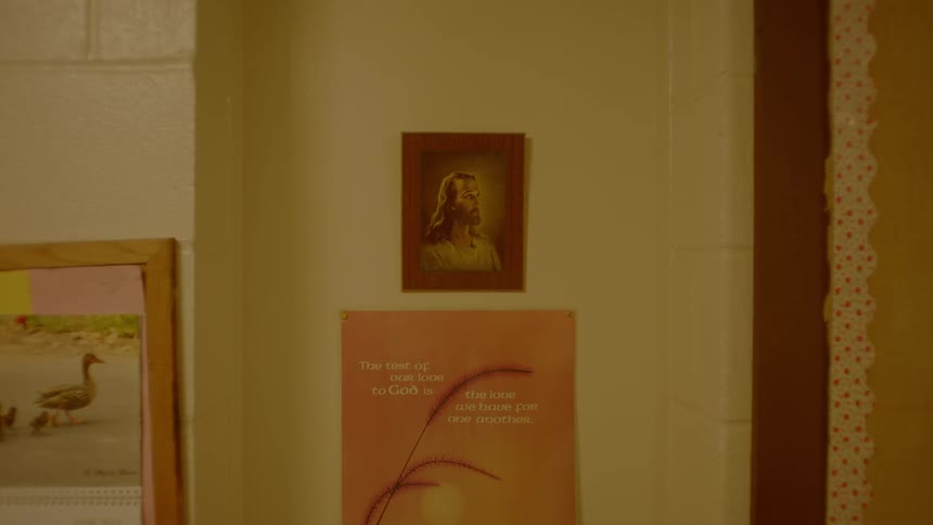 A picture of jesus hangs on a wall