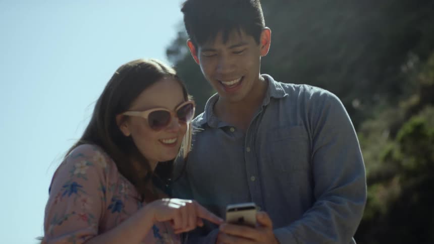 Two people looking at a phone