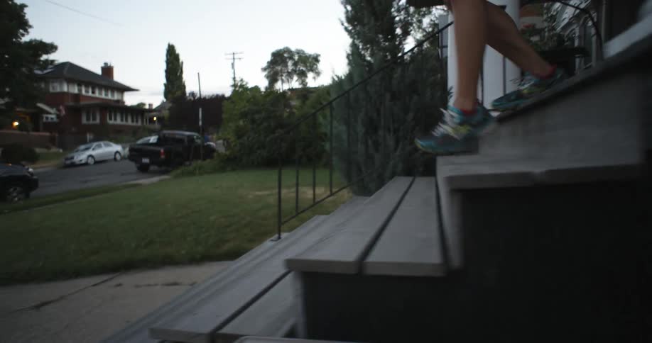 Woman walks out of her house in jogging gear