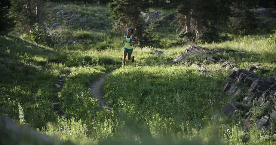 A woman jogs in the woods