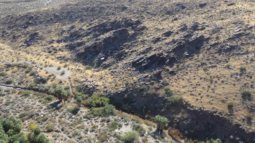Rough terrain with rocky hills dried brush and trees