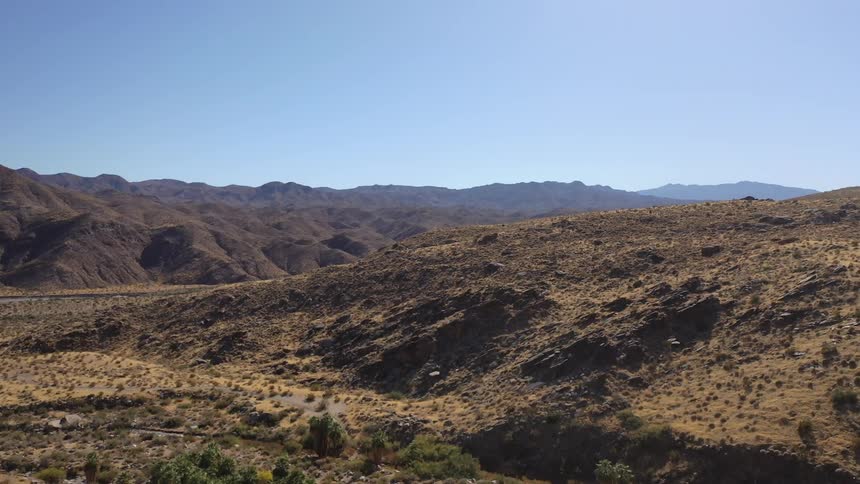 The trail runs along the hills on a sunny day