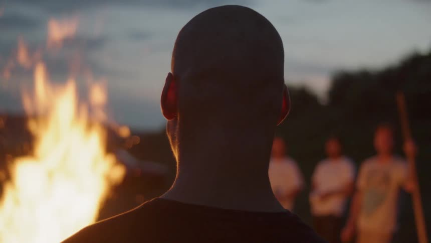 A group of people around a camp fire
