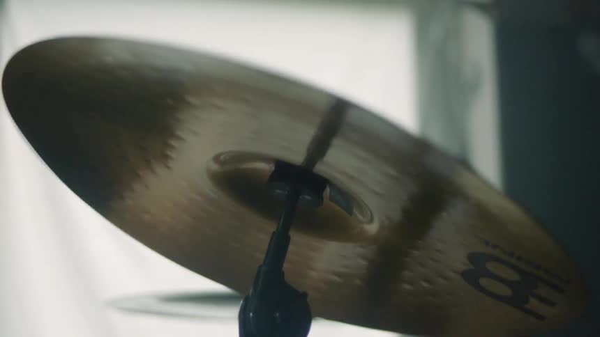 A drummer tapping on a cymbal