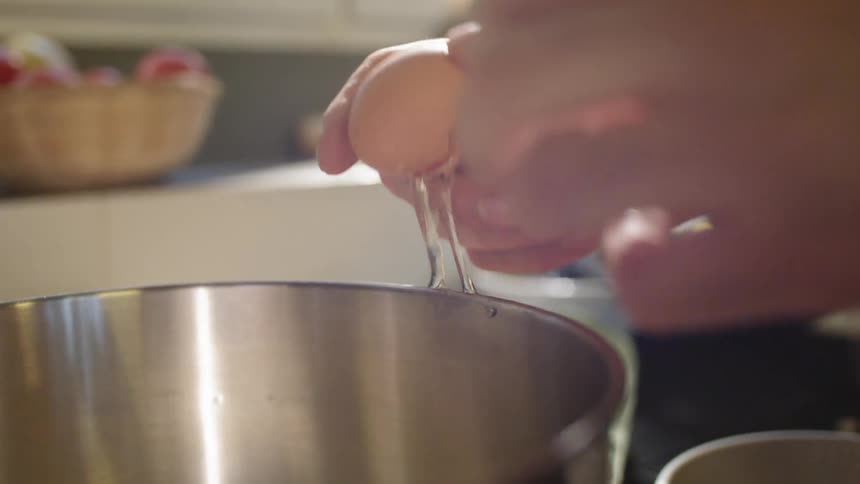 Human cracking an egg in a bowl