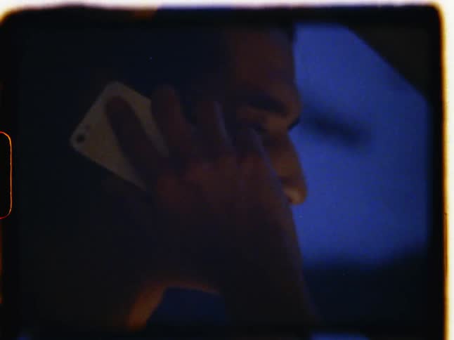 A person talks on a cell phone behind the wheel of a car