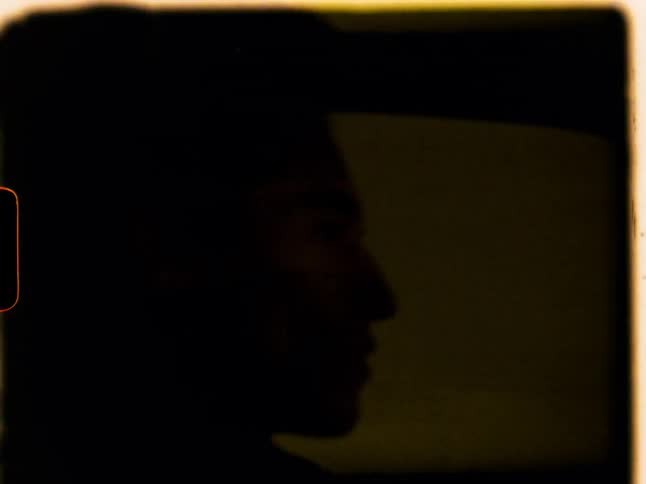 A white man driving a car through a tunnel at night