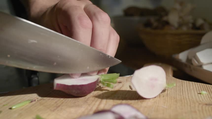 Someone chops radishes