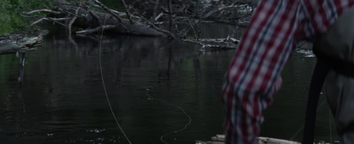 A man is fly fishing in a lake