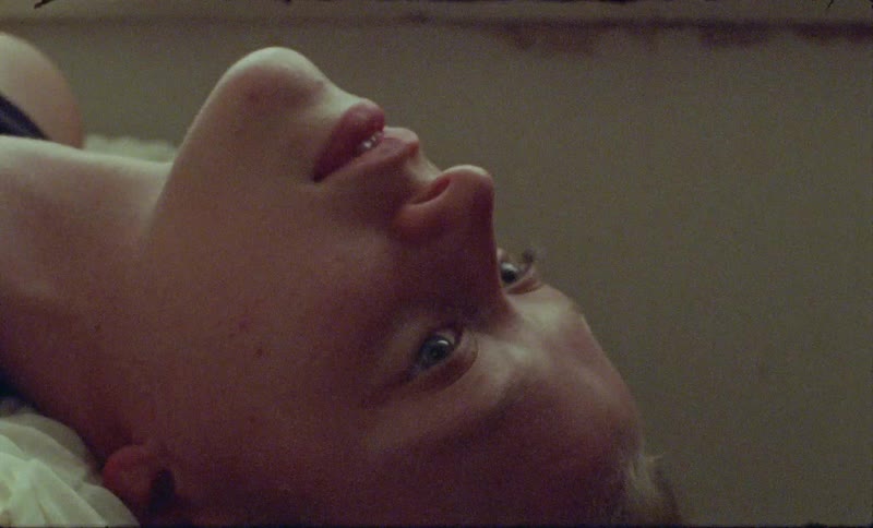 A woman is resting in bed