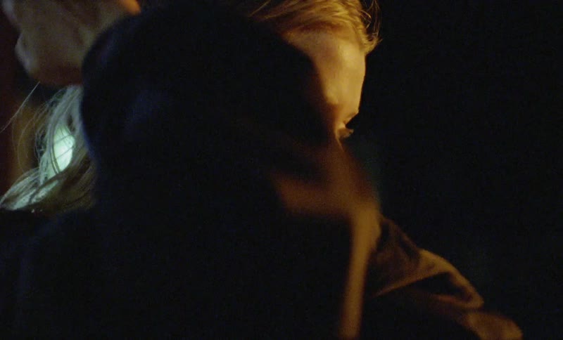 A woman looking out into the distance at night