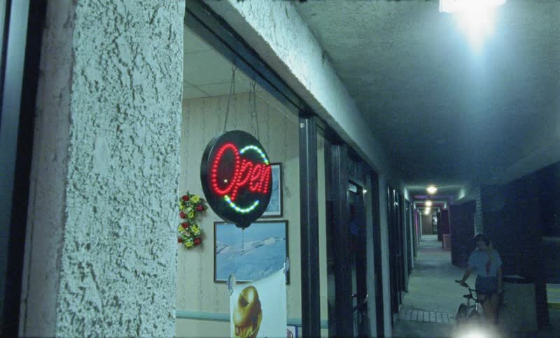 A woman walks next to stores