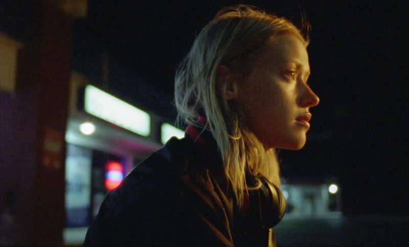 A woman is outside at night