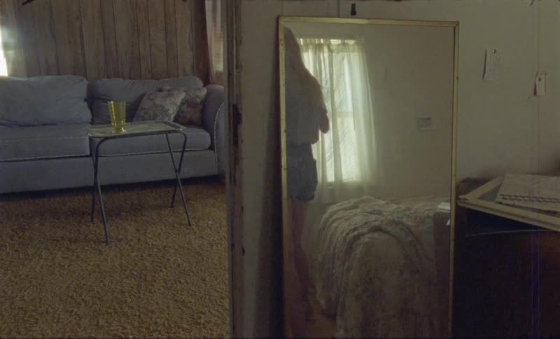 A woman walks into the bedroom