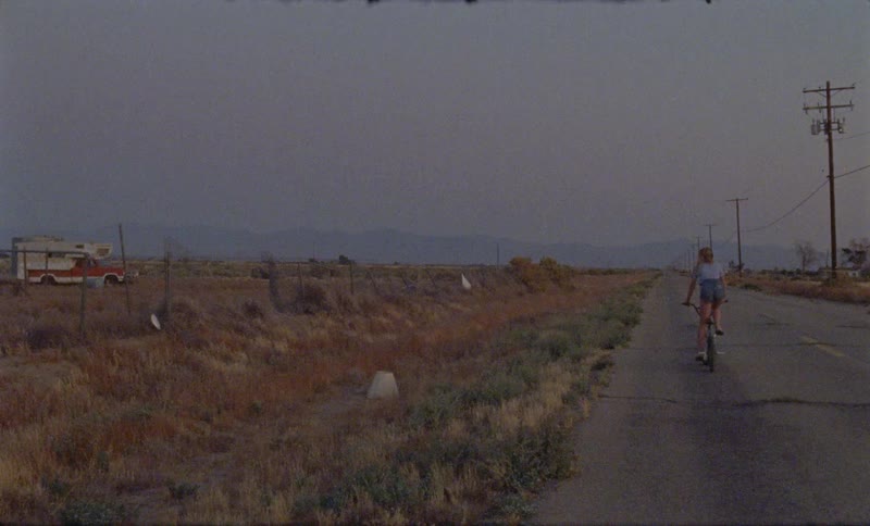A woman rides her bicycle down the road