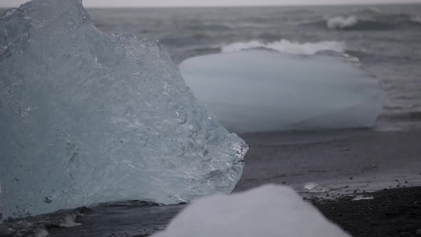 Water crashes to an ice covered shore