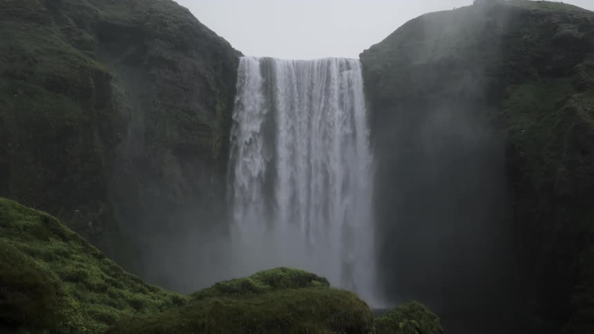 A waterfall cascades over a cliff