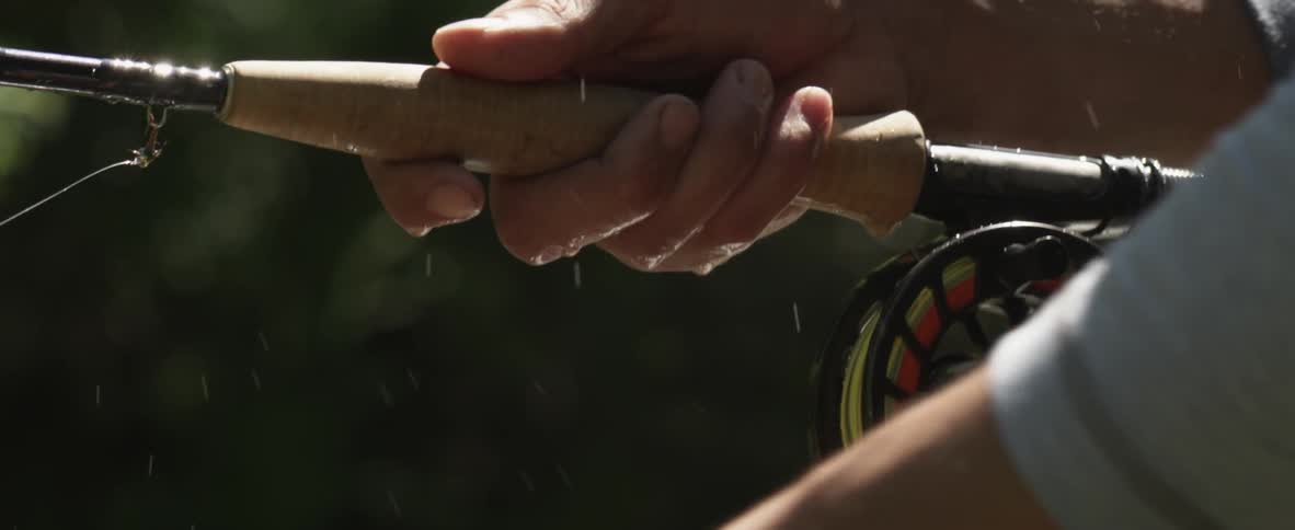 A person unwinds some fishing line