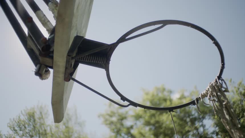 A basketball hoop with a tattered net