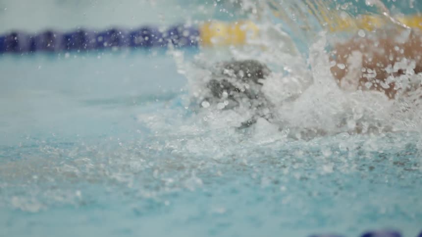 A man swims in a pool