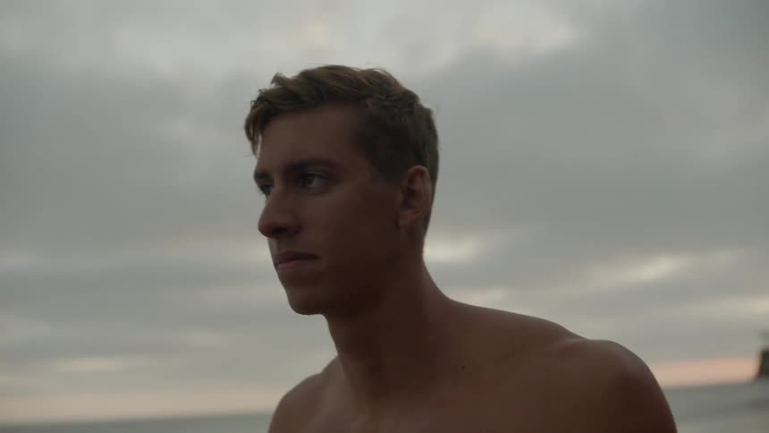 A man walking forward on the beach