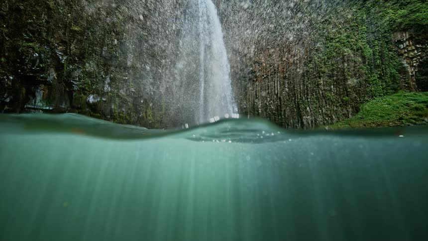 Waterfall sprays water into the air and causes small waves