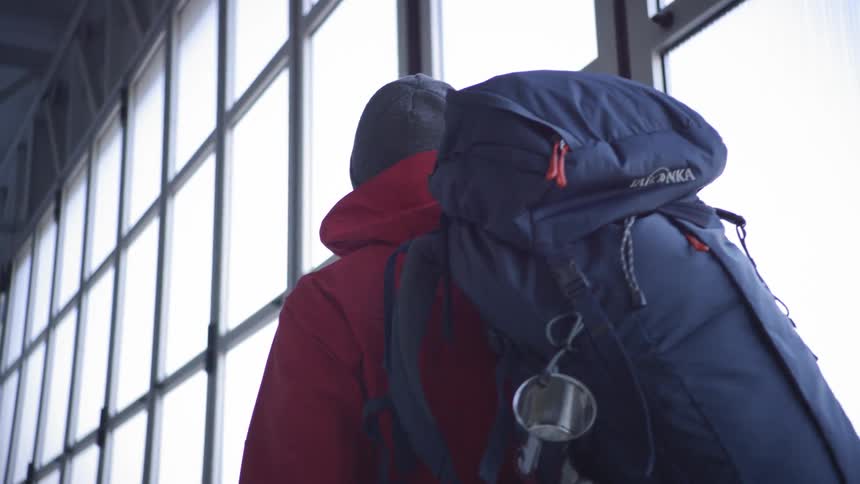A backpacker with a backpack walking