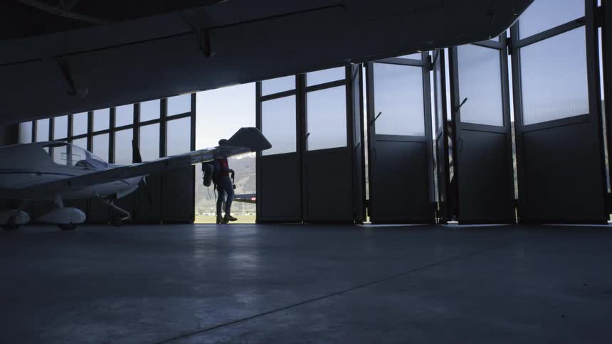 A man walks out of a hangar