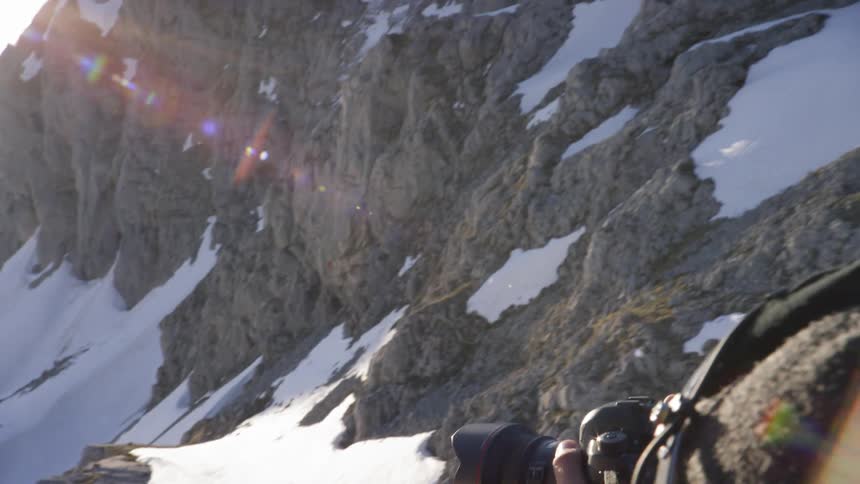 A person takes a photograph from a helicopter