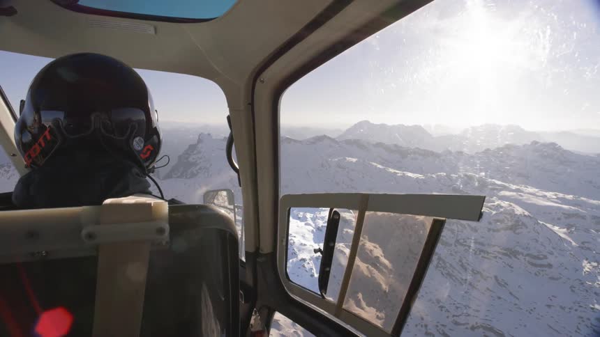 A view of a mountain range from a helicopter cockpit