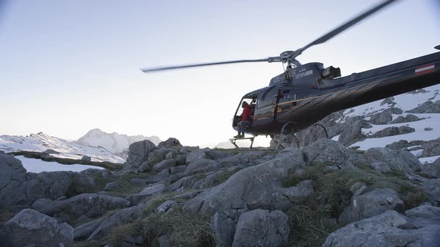 A helicopter has landed on a mountain area