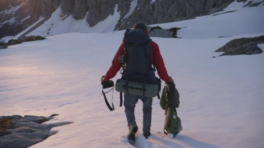 Peron hiking down a snowy terrain