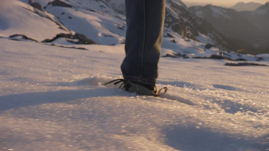 A young man runs through the snow