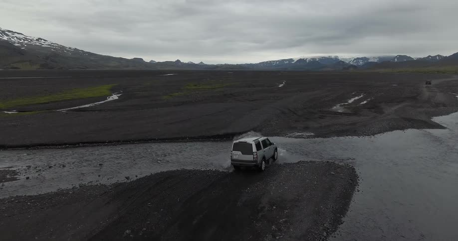 Suv driving through water and muddy terrain