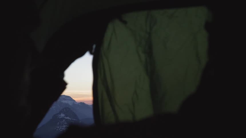 A person in a tent zips it shut
