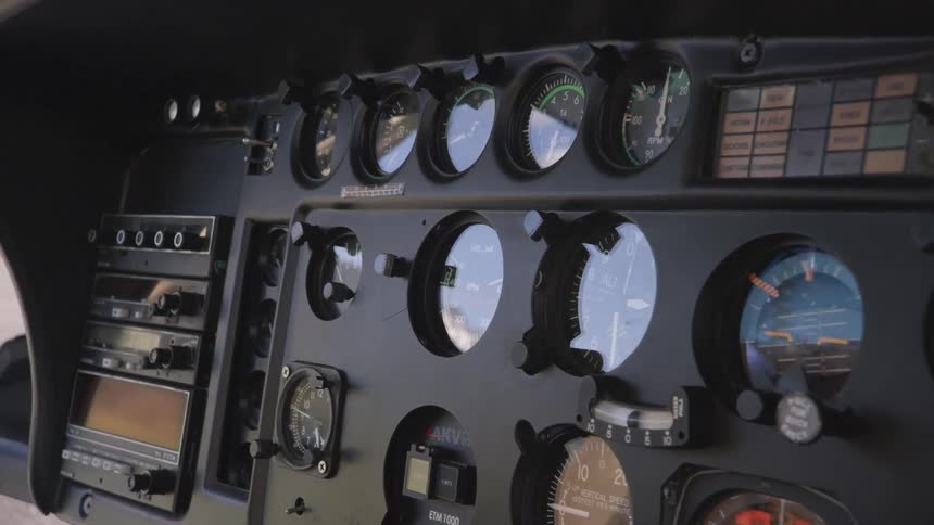 A plane cockpit with gauges and buttons
