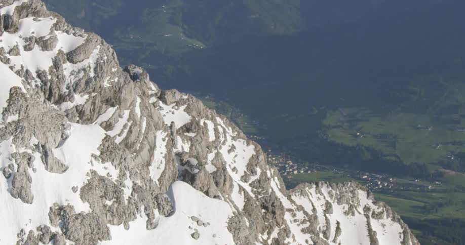 Snow covered mountain peaks with a village far below