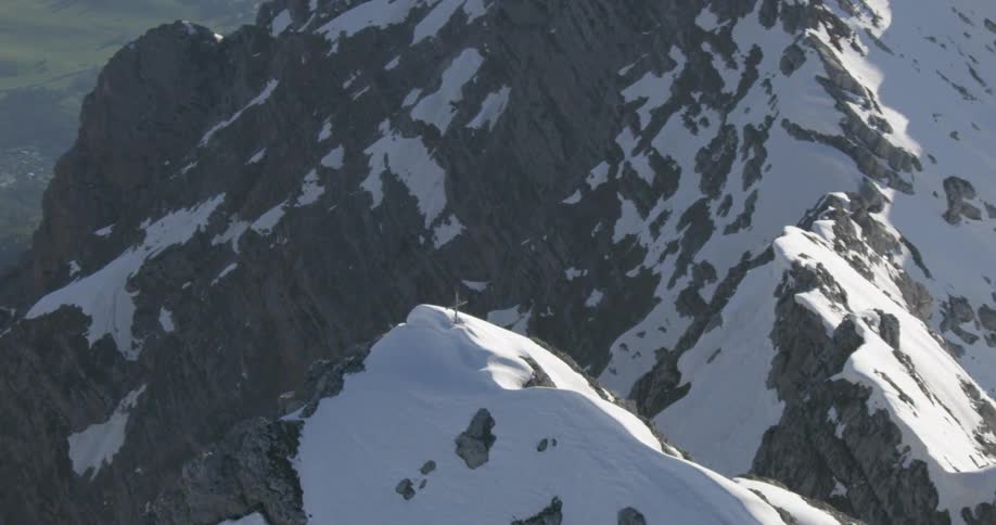 A cross is at the very top of the mountain