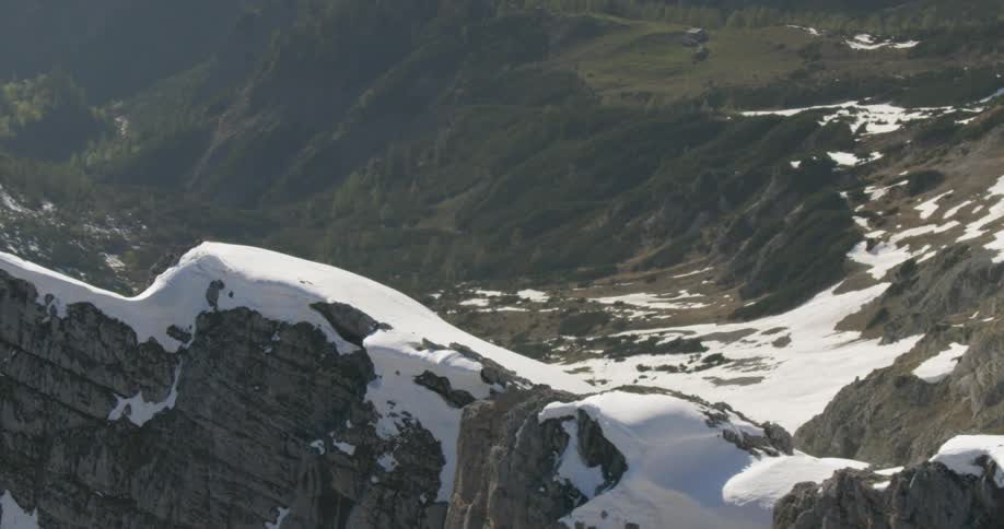 An aerial view of cliffs and hills are displayed