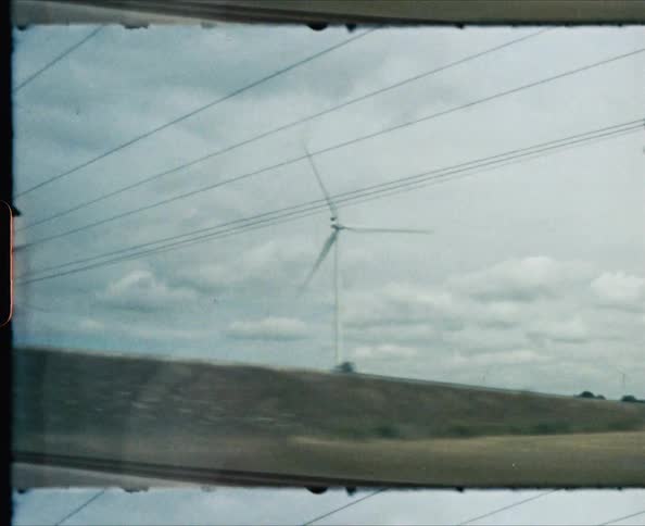 A scenery of wind turbin from a train