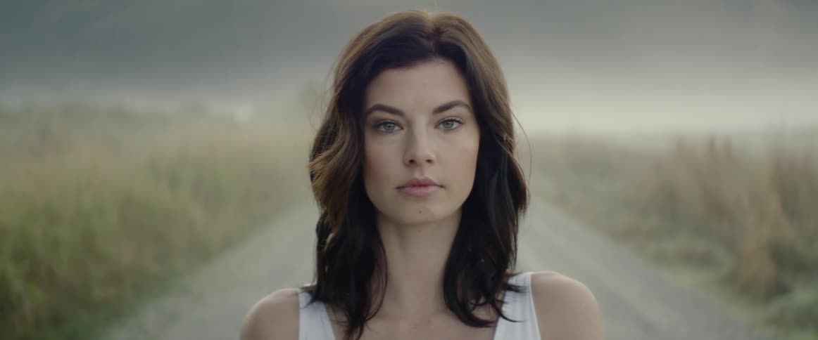 A woman is standing outdoors