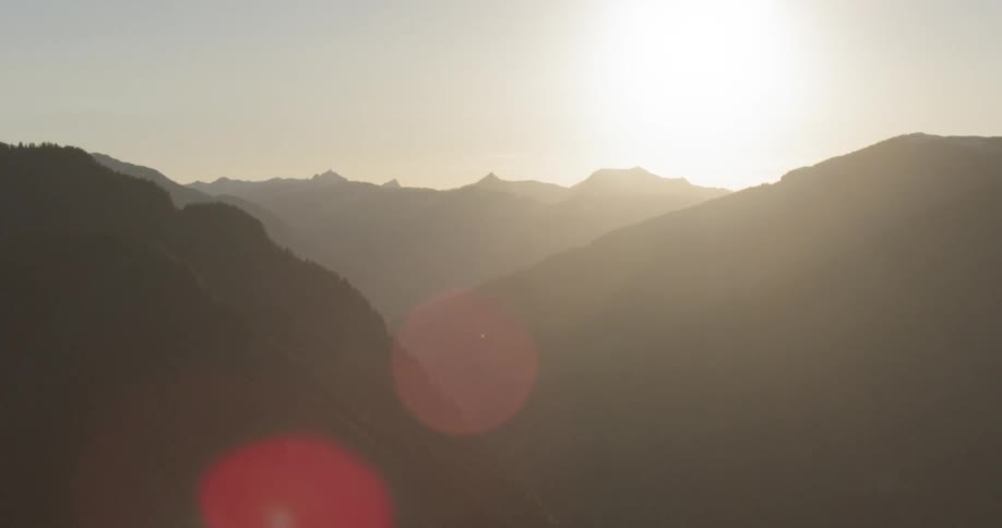 The mountain range is covered with fog