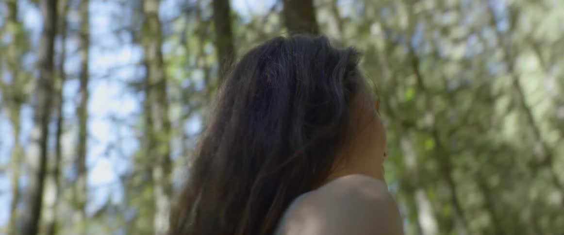 Woman spinning in the forest