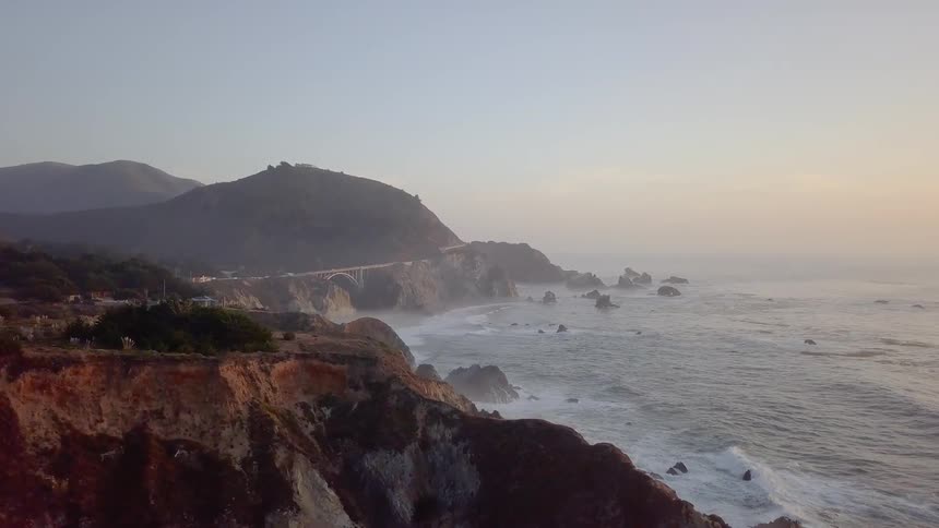 Sunset in Big Sur with Bixby Creek Bridge in the distance