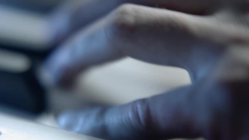 A hand plays the piano
