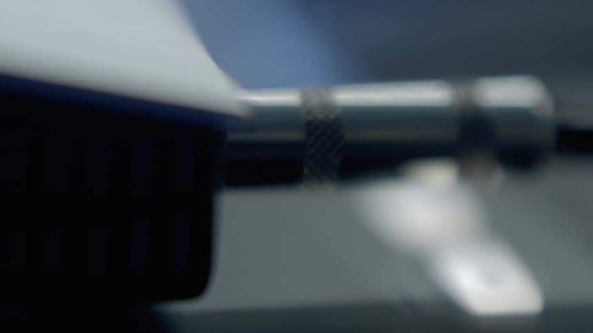 Fingers plug in a stereo audio cable